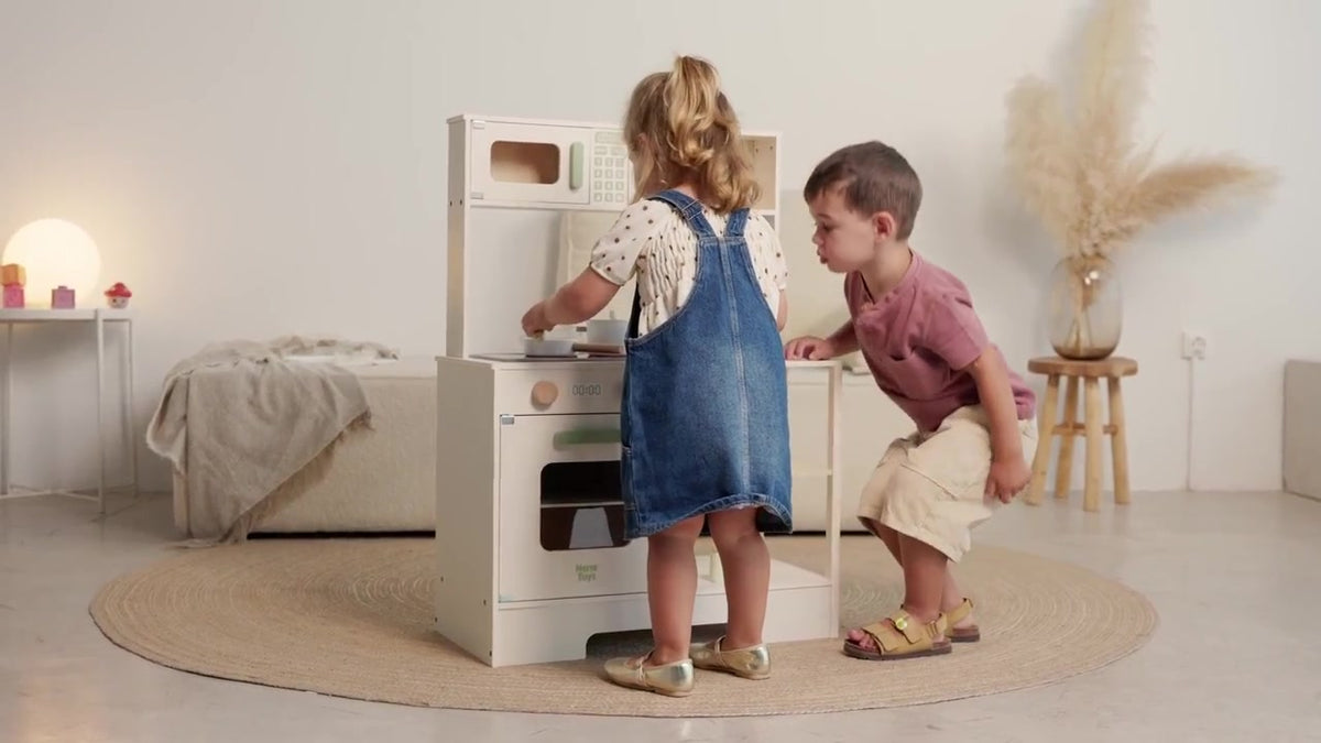 Two children playing together with the Nordic wooden kitchen