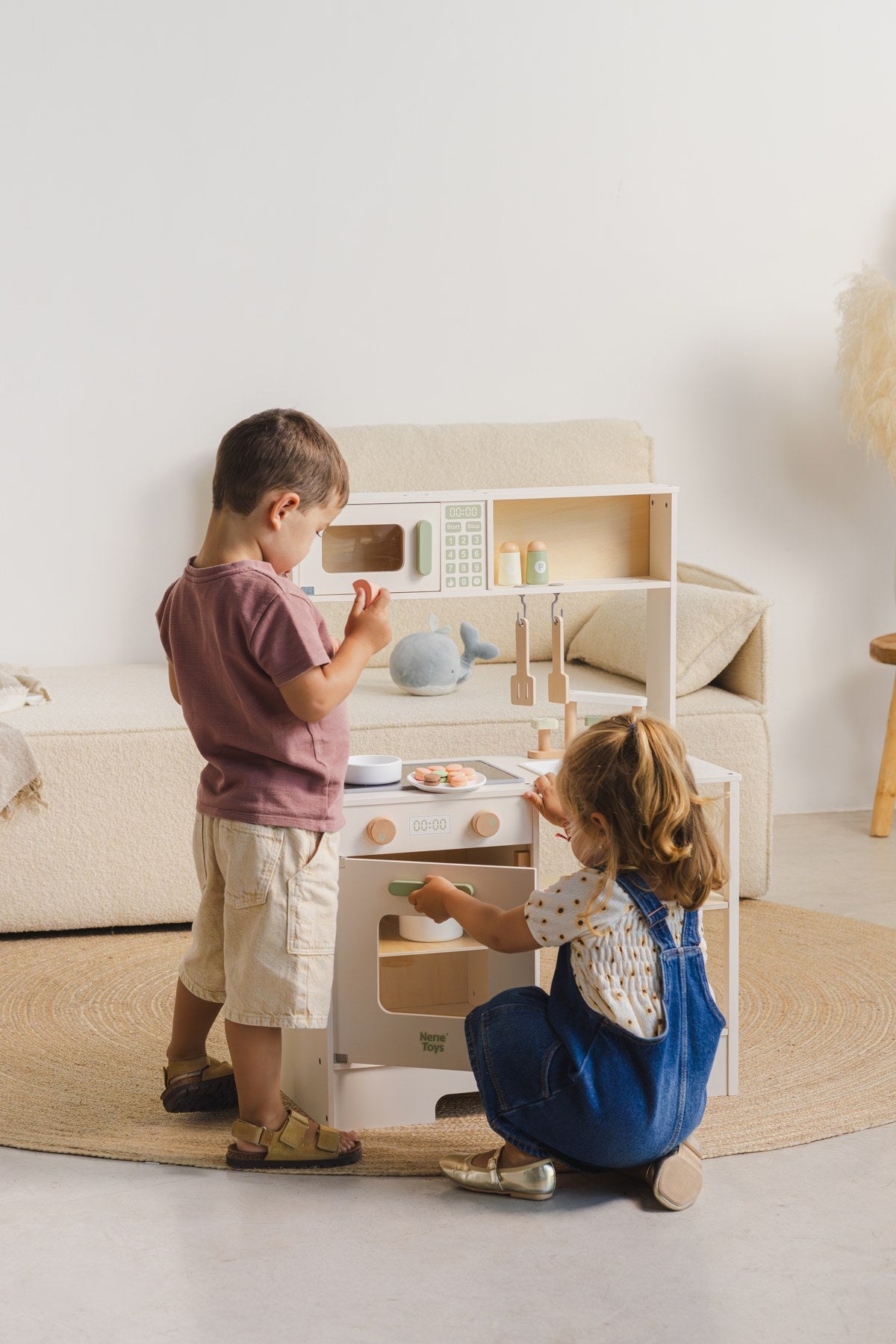 Two children cooking together with the Nene Toys Nordic wooden play kitchen