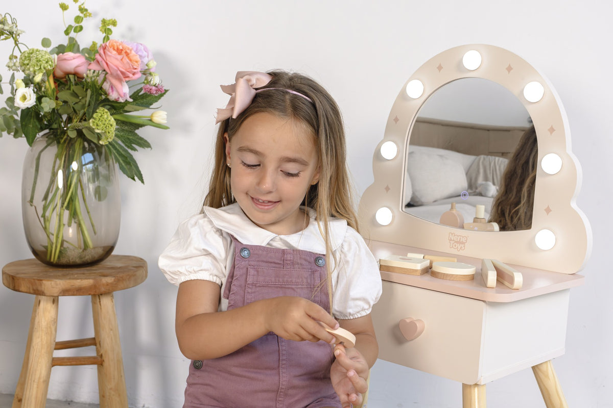 A child imagining salon stories with My First Vanity Table and its wooden play accessories